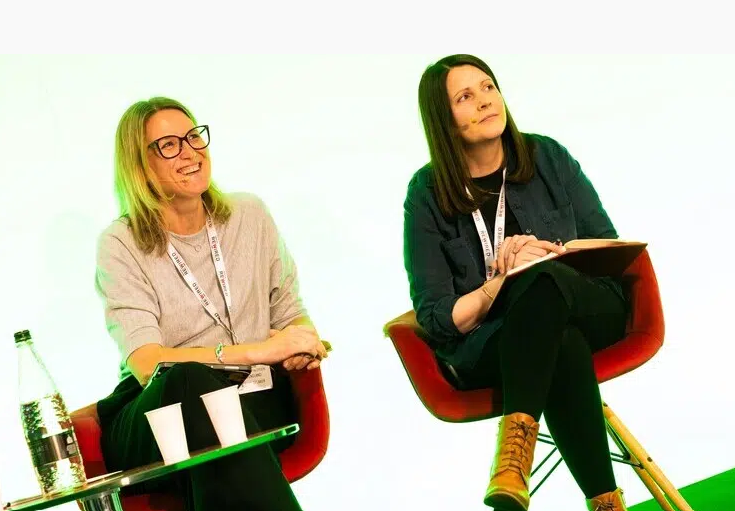 Liz Clow and Rachel Hope on a stage presenting at Digital Health Rewired in spring 2026.